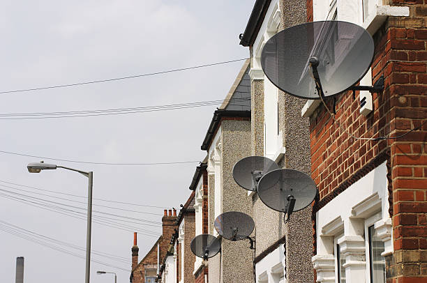 Satellite dishes get mixed reception in London A street in Tooting, south London, packed with black satellite receiver dishes. Do they spoil the view? wandsworth photos stock pictures, royalty-free photos & images