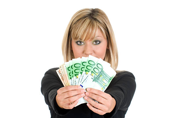 Businesswoman with handful of cash stock photo