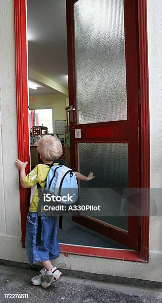 A Boy Waiting At A Door For The First Day Of Kindergarten Stock Photo - Download Image Now
