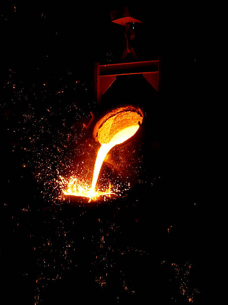 Iron Casting Molten metal poured from lathe for iron casting melting metal stock pictures, royalty-free photos & images