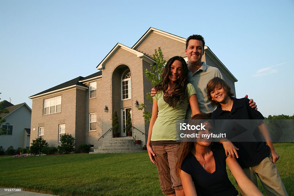 Famille debout devant leur maison - Photo de Famille libre de droits