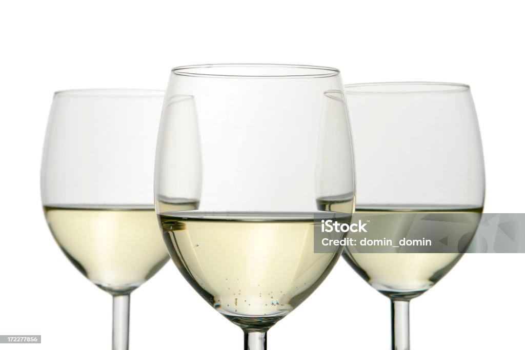 Group of three wine glasses isolated on white White wine on white background. Alcohol - Drink Stock Photo