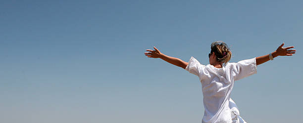 istock A woman stretching her arms in freedom 172277953