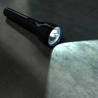 A lit flashlight on a dark background. 3D rendering with raytraced textures and HDRI lighting.