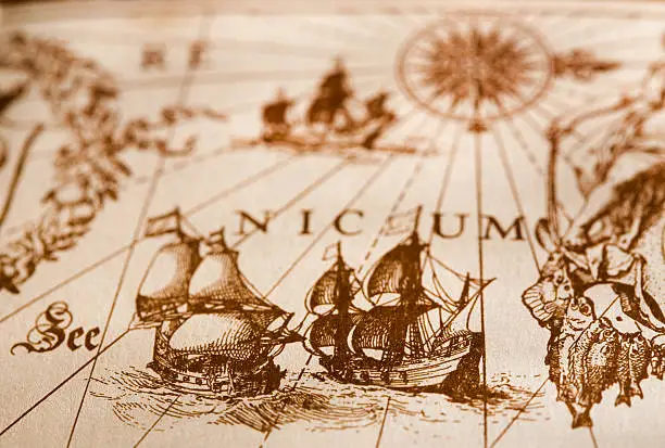 old map with ship and compass shallow depth of field