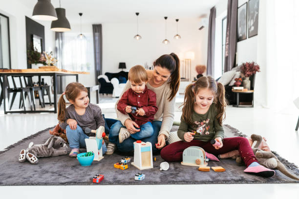 istock Mother with three kids playing at home 1722781771