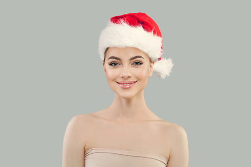 Happy Christmas model wearing red Santa hat, Xmas portrait