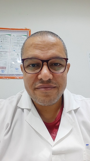 Selfie at work, medical doctor wearing lab coat, glasses