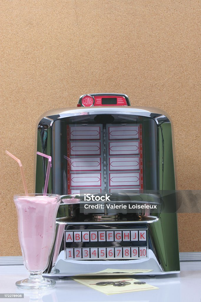 Tabletop jukebox and milkshake Tabletop Jukebox with Strawberry Milkshake, coins and bill. Jukebox Stock Photo