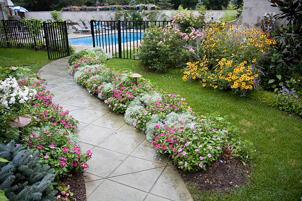 Garden walk leading to pool area. Wet with rain.