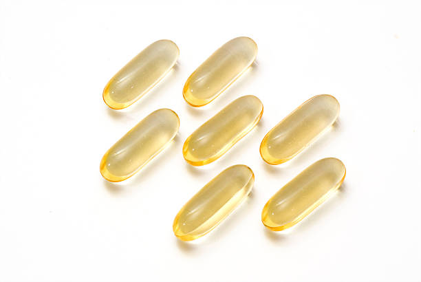 Vitamin E Vitamin E gel caps cod liver oil fish oil vitamin a pill stock pictures, royalty-free photos & images