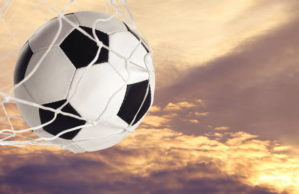 istock Soccer ball in net against sky at sunset 1722805211