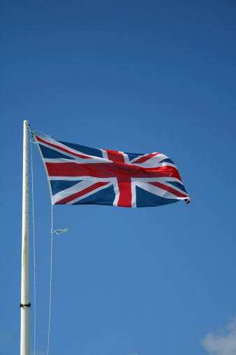 This is a high quality image of the British flag flying against a clear blue sky.