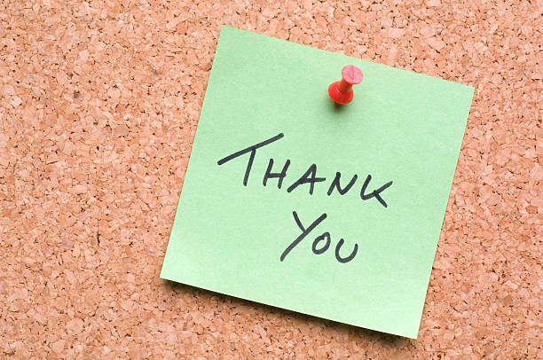 Green Thank You Post-It on cork