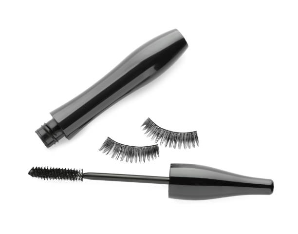 istock Black mascara and fake eyelashes on white background, top view 1722806318