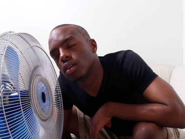 istock Very hot day, Young man cooling by the fan 172280773