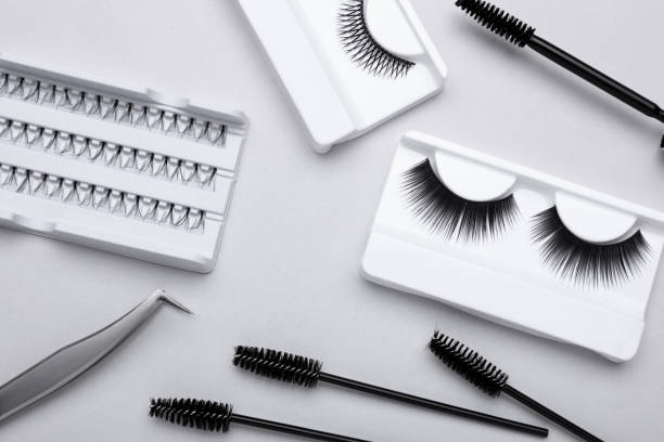istock Flat lay composition with fake eyelashes, brushes and tweezers on light grey background 1722809722