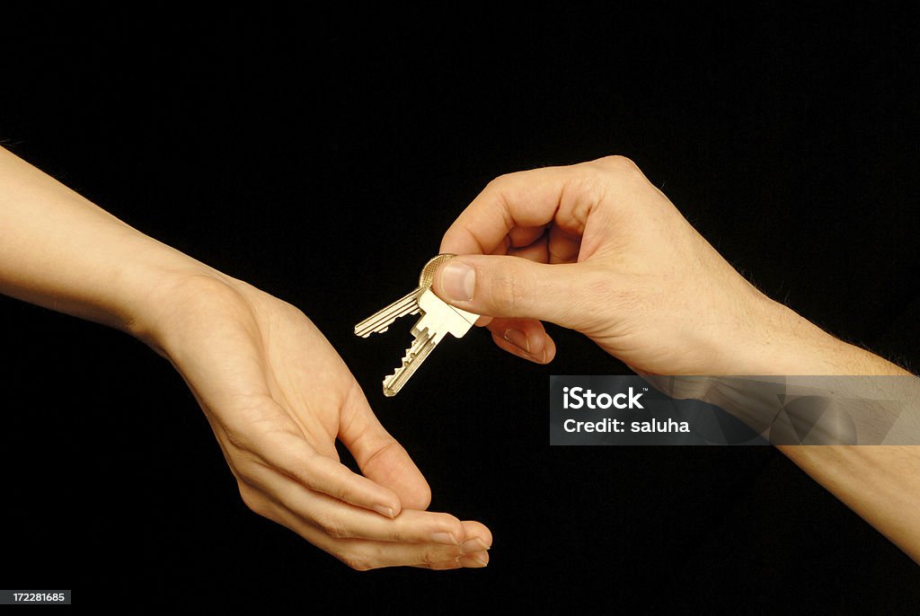 Passing Over the Keys. A hand handing over a set of keys to the new owner. Car Stock Photo