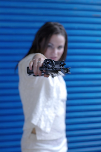 woman pointing an uzi (automatic weapon)