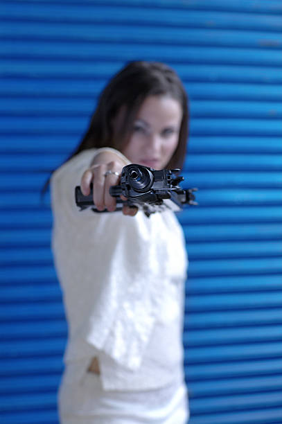 Animosity with an uzi woman pointing an uzi (automatic weapon) animosity stock pictures, royalty-free photos & images