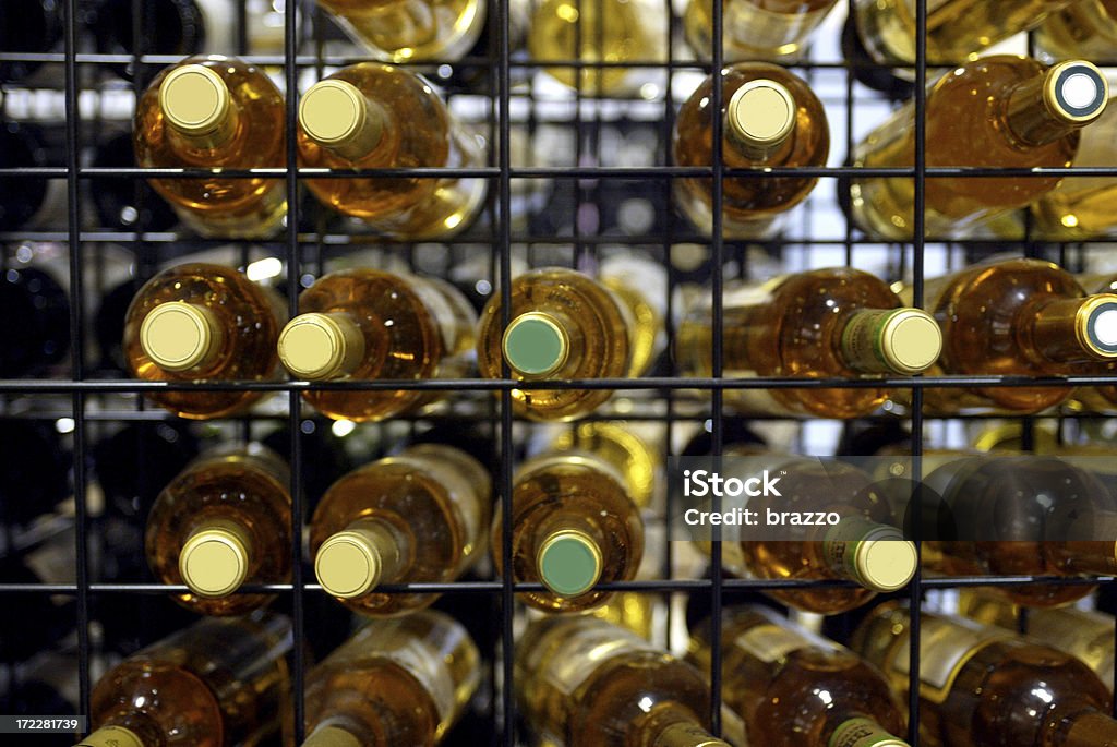 White wine bottles on a wire rack Wine bottles in a rack with corks facing the camera. Collection Stock Photo