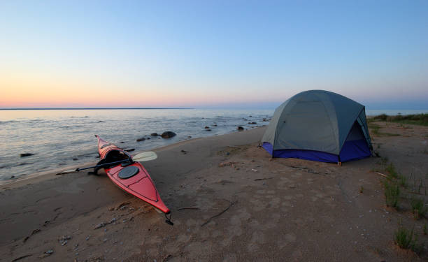 istock Kayak and Tent on Secluded Beach at Sunset 172281904