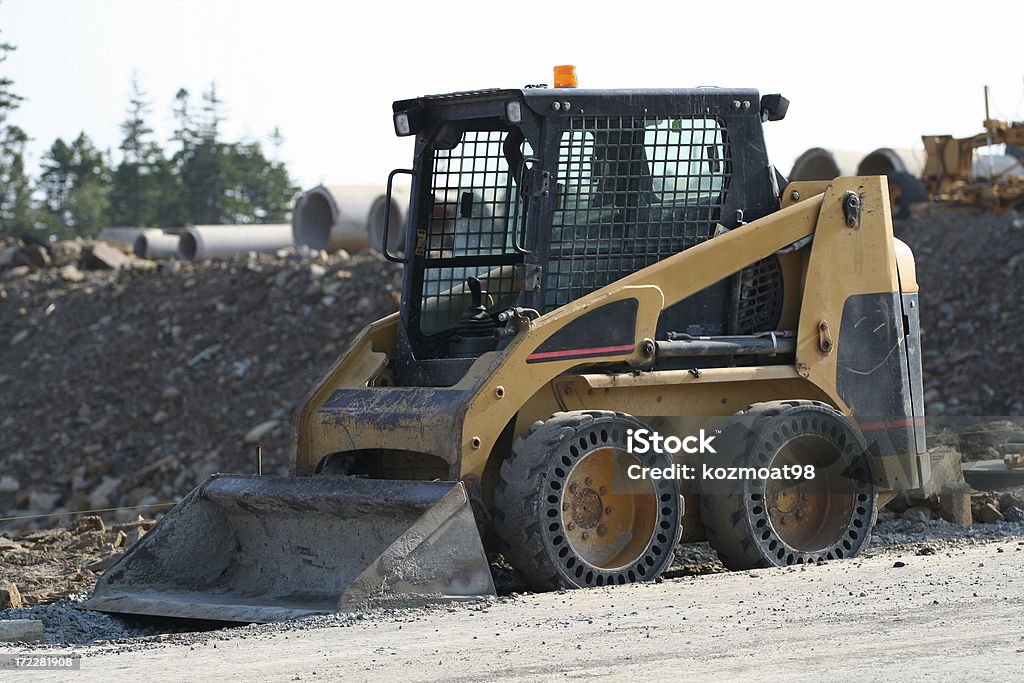 Mini Earth Mover Small highly maneuverable construction vehicle with front bucket. Backhoe Stock Photo