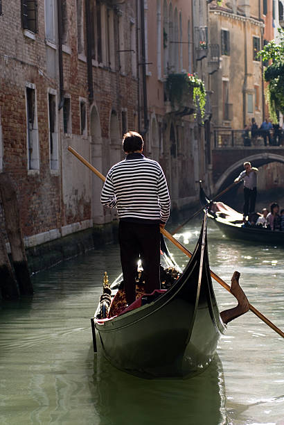 istock Gondolier in Narrow Venetian Canal 172282648