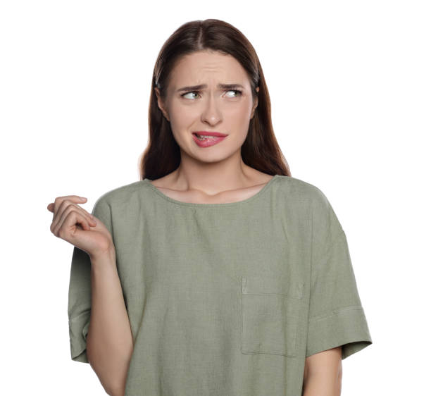 istock Embarrassed young woman in shirt on white background 1722828587