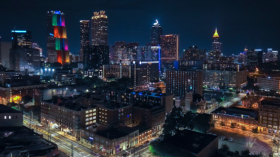 Big city lights ablaze at night: Atlanta, GA Downtown district comes alive. Office skyscrapers illuminate the streets