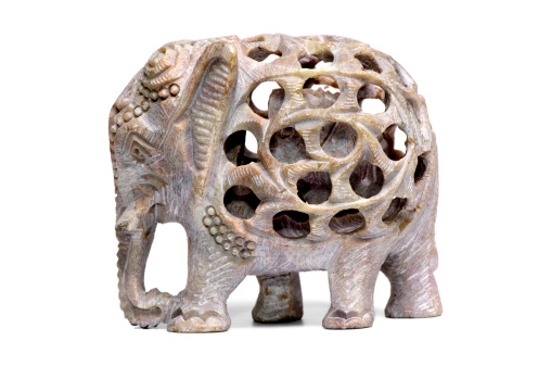 Isolated elephant carving from India.  Smaller elephant carved inside the body of the larger elephant without any breaks or joining.  Replica of an ancient Indian artifact found in the southern Indian province of Tamil Nadu.