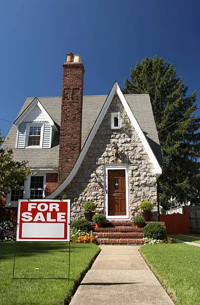 House for sale with sign.