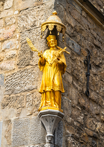 Golden St. Nepomuk on the corner of the Haus Lowenstein in Aachen, Germany. The building was built in the 1300s