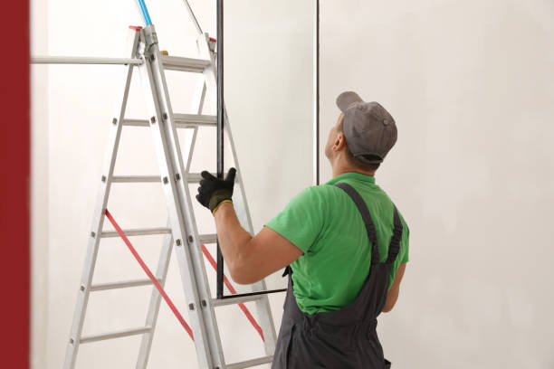 istock Worker holding double glazing near ladder indoors. Window installation 1722848061