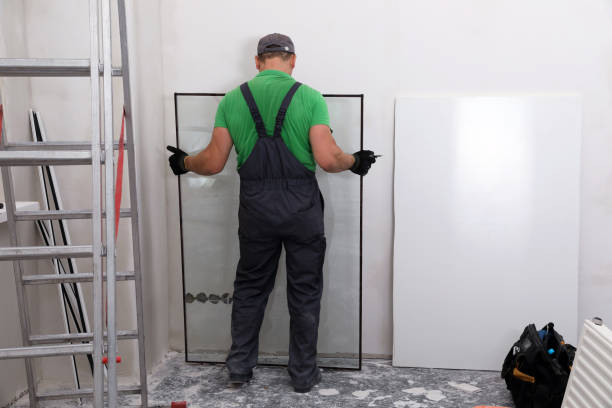 istock Worker in uniform taking double glazing window indoors, back view 1722850224