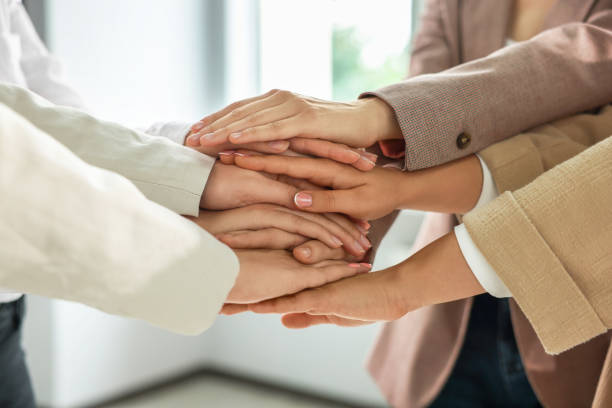 istock Group of people holding hands together indoors, closeup. Unity concept 1722851292