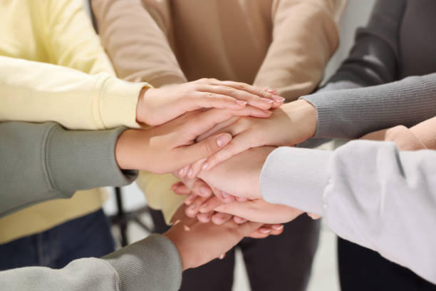 istock Group of people holding hands together indoors, closeup. Unity concept 1722851295