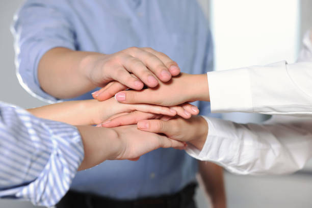istock Group of people holding hands together indoors, closeup. Unity concept 1722851302