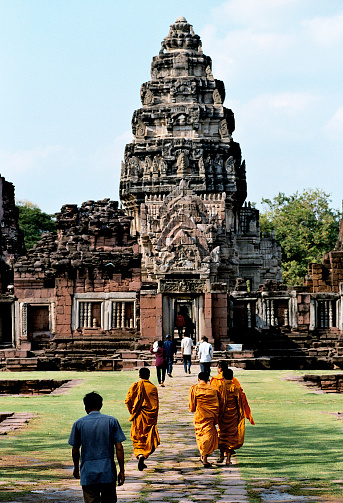 Buddhist Monks on their way to the temple to Buddha - shot from Pra Hin Phimai - Thailand