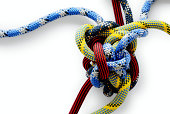 Close-up of multicolored Gordian knot on white background