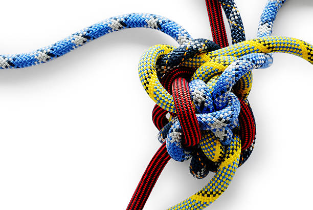 Close-up of multicolored Gordian knot on white background Ghastly knotty ropes (isotated on white with soft shadow + clipping path) tangled stock pictures, royalty-free photos & images