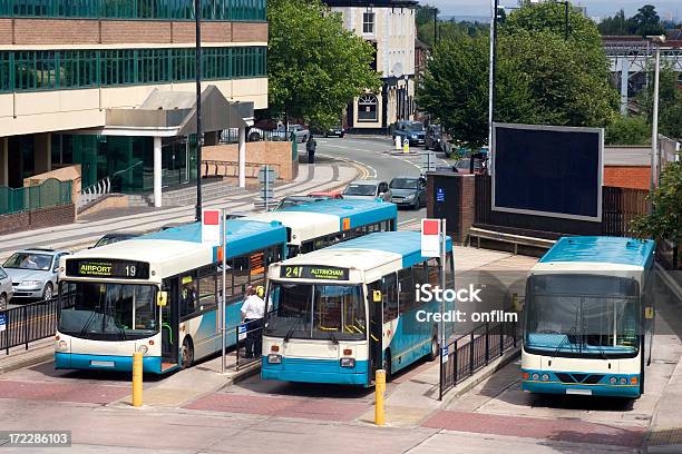 Blue Buses Waiting At A Station In A Small City Stock Photo - Download Image Now - Bus, UK, Coach Bus