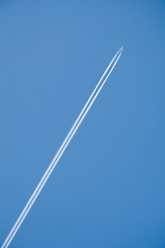 White airplane trace on blue sky