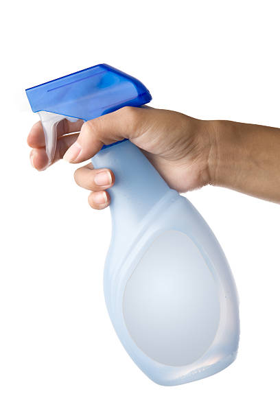 holding spray bottle stock photo