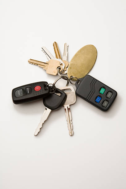 Key ring with car keys and immobilizer on white background stock photo