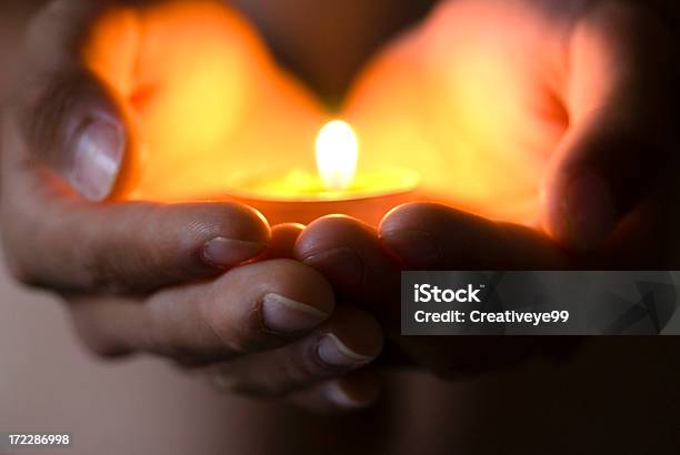 Hope Illuminates Stock Photo - Download Image Now - Candle, Praying, Flame