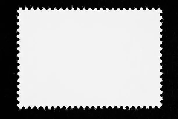 Photo of Close-up of a blank white stamp, isolated on black