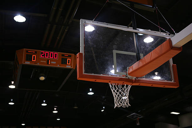 Basketball goal and score board in the background with a new game about to start.