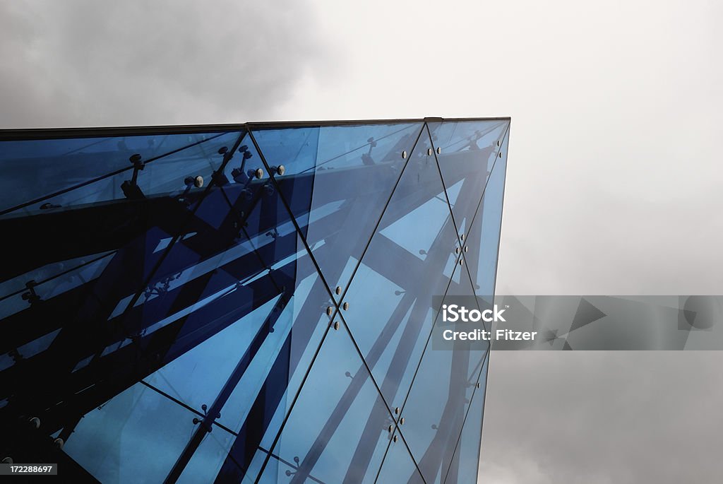 triangle "top a huge, funky, blue glass pyramid and a cloudy gray sky." Cool Attitude Stock Photo