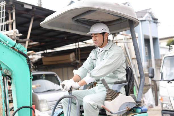 istock Middle-aged Asian male worker operating construction machinery at a construction site 1722894030